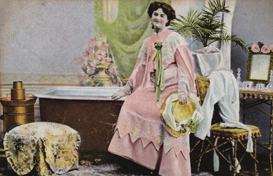 Woman sitting on edge of bath