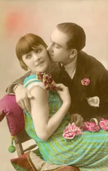 Young man kissing girl on cheek
