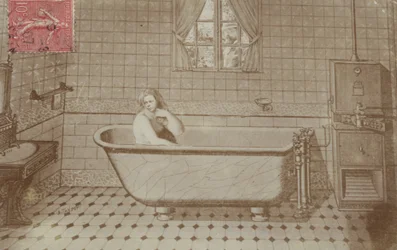 A woman in the bath in a bathroom
