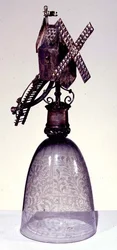 Drinking glass with metal foot in shape of a windmill, engraved with diamond point