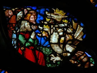 The west rose window depicting a scene from the Book of Revelation: Adoration of the dragon
