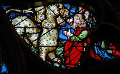 The west rose window depicting a scene from the Book of Revelation: Adoration of the beast