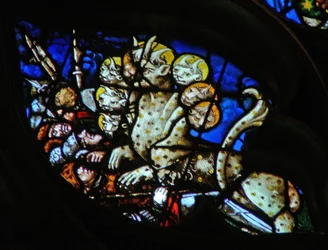 The west rose window depicting a scene from the Book of Revelation: Beast makes war against the saints