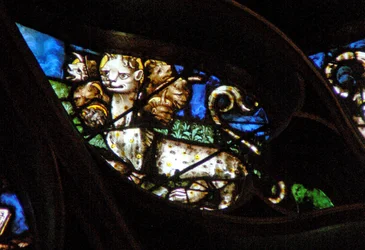 The west rose window depicting a scene from the Book of Revelation: Beast with seven heads comes out of the sea