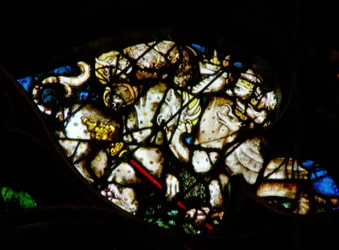 The west rose window depicting a scene from the Book of Revelation: Dragon gives power and authority to the beast