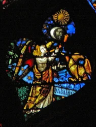 The west rose window depicting a scene from the Book of Revelation: Fourth trumpet sun, moon and stars darkening, and the eagle as the angel crying Woe, Woe