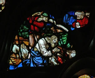 The west rose window depicting a scene from the Book of Revelation: Two witnesses are put to death with a turbaned figure looking on