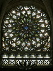 Window S rose depicting the south rose window, built in the early C16, contains much of its original decorative glass, though it was much restored in 1865