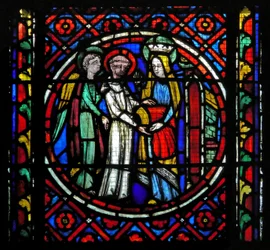 Window s1-C an angel pushes the re-clothed St Bonnet to the Virgin. She gives him a red chasuble with which to celebrate Mass for her