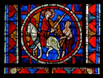 Window depicting the Charity of St Martin: he divides his cloak