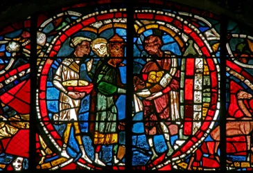 Window depicting a scene from the Prodigal Son story: he receives his inheritance