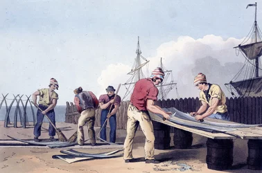 Fishermen scraping and cleaning the remains of whales from 