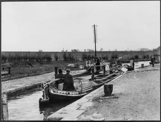 Two canal barges passing through a lock on the Grand Union Canal near Marsworth