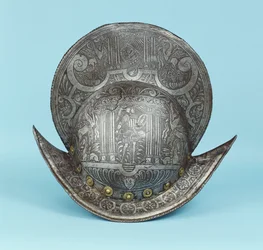 A comb morion, etched with cherub heads, sphinxes and winged horses, the centre with a pseudo classical warrior in contemporary armour with sword and shield