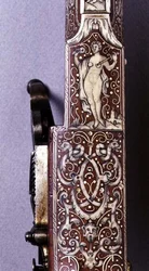 Handle of a wheel-lock rifle decorated with ivory figures and arabesques