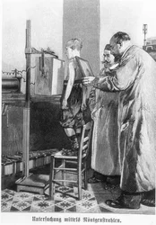 Wilhelm Konrad Roentgen x-raying a young boy, from a book by Hans Kraemer, c.1898-99