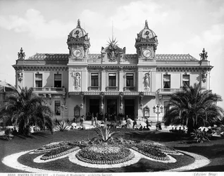 Facade of the Montecarlo Casino. A crowd of people animates the staircase at the entrance