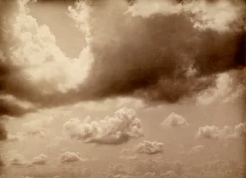 Stretch of Sky with Large Clouds. The Silhouette of the Hills Can Be Made Out Below
