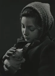 Girl holding a white kitten in her arms
