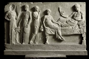 Greek art: low marble votive relief dedicated to Dionysus Bacchus by comedians. It represents “The Bacchae” by Euripides, 410 BC, Athens, National Archaeological Museum. Bacchae (from the tragedy by Euripides, 480-406 BC). Marble votive relief dedic