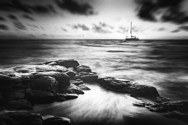Sailboat Over Rocky Coast