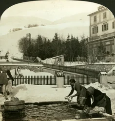 Women washing clothes at the public fountain in midwinter, Zuoz, Switzerland