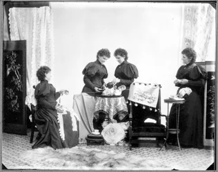Multiple exposure of Hannah Maynard - two having tea, one holding a skein of cotton, one winding it into a ball, c. 1895