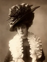 Close-up of a young woman in clothes from the beginning of the 20th century