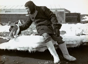 Man with a penguin during the English expedition to the Antarctic