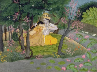 Radha and Krishna embrace in a grove of flowering trees