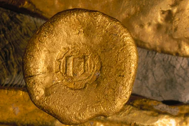 A glittering fortune in gold and silver has been recovered from the seafloor. Treasures like this gold button were shipped from the New World to Seville by way of Cuba. Courtesy of Office of the Historian of the City of Havana.