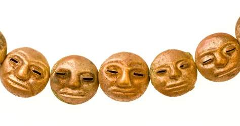 A necklace found around the mummy’s neck with small gold faces.
