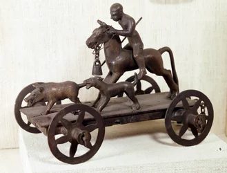 Iron Age: miniature bronze chariot from Mérida depicting a wild boar hunting scene. From Mérida, Spain. Dimensions: 0,12x0,28 m. Saint-Germain-en-Laye, National Archaeology Museum