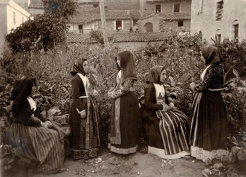 Group of women wearing traditional costumes in garden, Sardinia, Italy