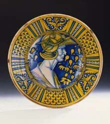 A Deruta lustred portrait dish painted in blue and lustred in yellow depicting a warrior in a helmet with a winged griffin, c.1525