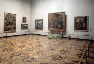 Hall of the Museum Presenting The Adoration of the Magi by Vinci, the Baptism of Christ by Verrocchio and Vinci, the Holy Trinity with Virgin and Saints by Signorelli