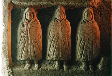 A relief sculpture depicting local deities cloaked against the cold. Housesteads Roman Fort