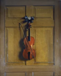 Violin and bow hanging on a door