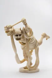 Okimono in the shape of a demon holding a stick