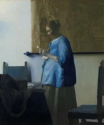 Woman in Blue Reading a Letter