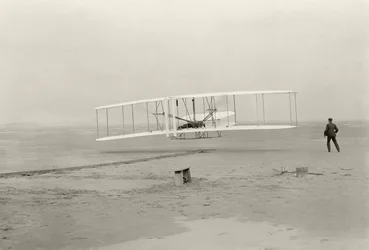 The Wright Flyer I makes its first flight of 120 feet in 12 seconds, at Kitty Hawk, North Carolina