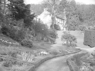 A Pale Building Surrounded by Landscaped Gardens