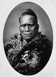 A Maori chief with elaborately tattooed face and weather cloak