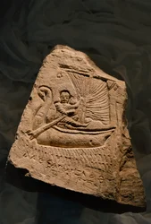 Limestone funerary stela showing the deceased, a young boy, reclining in a boat, Roman Period, 2002 (photo)