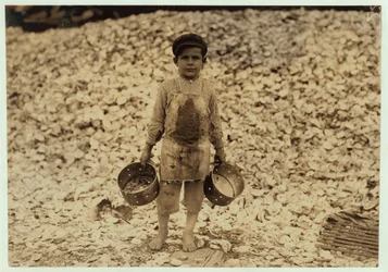 5 Year Old Migrant Shrimp-Picker Manuel in Front of a Pile of Oyster Shells, Working for a Second Year at Dunbar, Lopez, Dukate Company, Biloxi, Mississippi, 1911