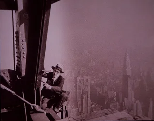 Empire State Building under construction, showing an inspector checking work