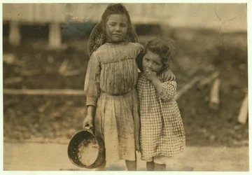 Maud and Grade Daly, 5 and 3 years old pick about a pot of shrimp each day for the Peerless Oyster Company, Bay St. Louis, Mississippi, 1911