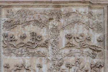 Naamah teaching child to read and Tubal-cain beating bells with hammer; Enos, son of Seth drawing with compass, Stories of Genesis, bas-reliefs by Lorenzo Maitani, first pillar, lateral facade of Orvieto cathedral, Umbria, Italy