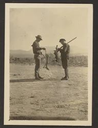 Fleckenstein and Man Holding Guns and Dead Jackrabbits