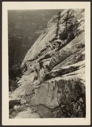 Hiker Climbing on Boulder